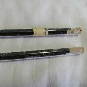 Two tubes of 2-3mm black beads, each in a vintage glass vial with a cork stopper